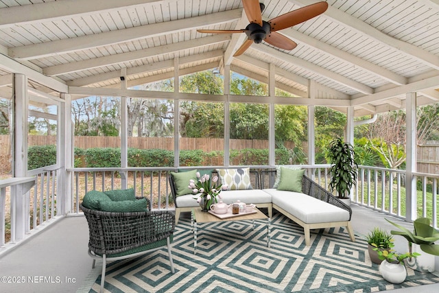 sunroom featuring vaulted ceiling with beams and a ceiling fan