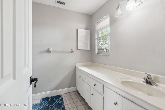 bathroom featuring vanity, tile patterned floors, visible vents, and baseboards