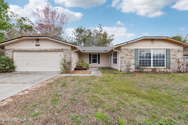 ranch-style home with a garage, brick siding, concrete driveway, and a front lawn