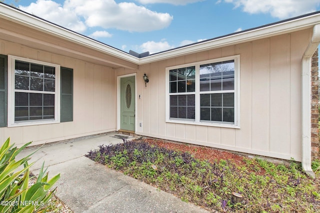 property entrance featuring board and batten siding