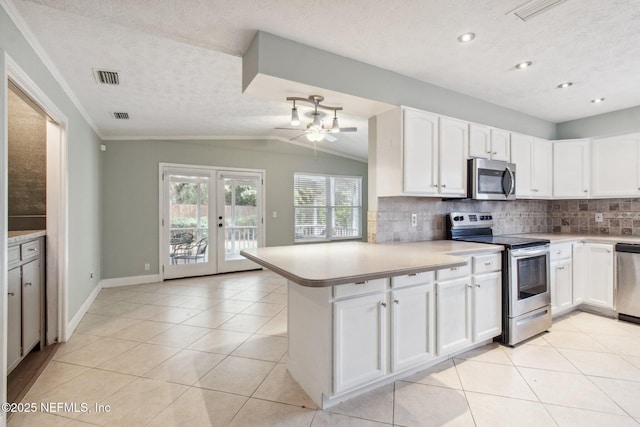 kitchen featuring stainless steel appliances, backsplash, visible vents, and french doors