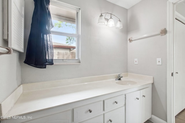 bathroom featuring baseboards and vanity