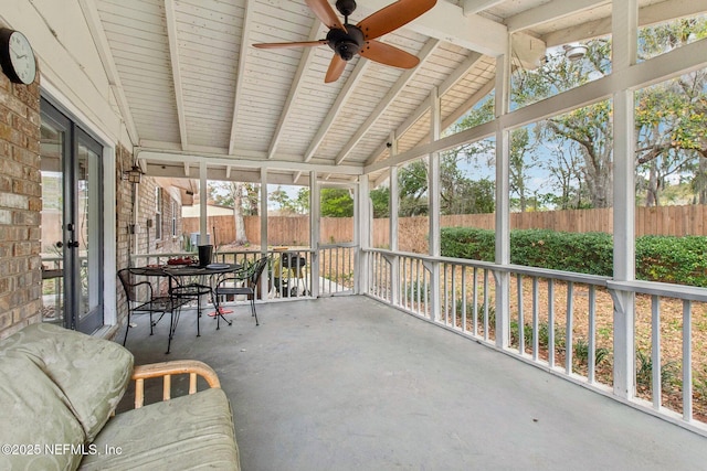 unfurnished sunroom featuring lofted ceiling with beams and ceiling fan