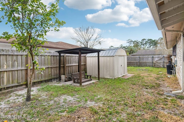 view of yard featuring an outbuilding, a storage unit, and a fenced backyard