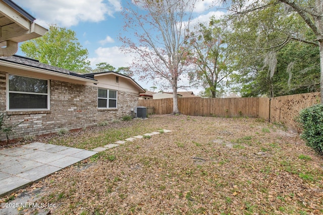 view of yard featuring cooling unit, a patio, and a fenced backyard