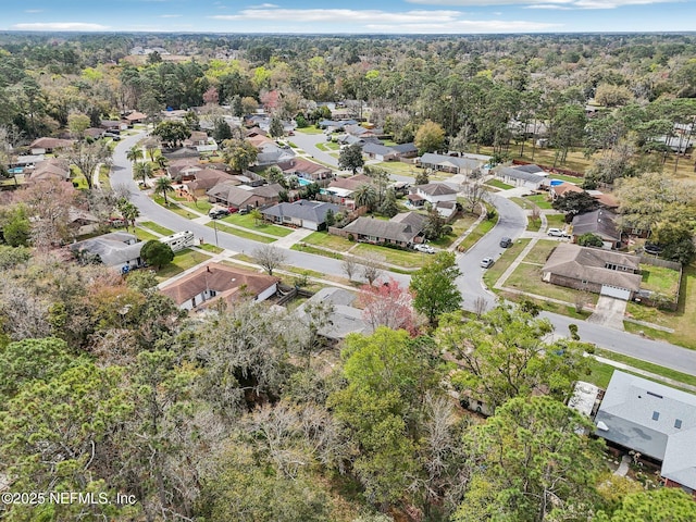 bird's eye view featuring a forest view and a residential view