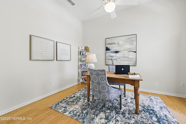 office space with ceiling fan, visible vents, baseboards, and wood finished floors