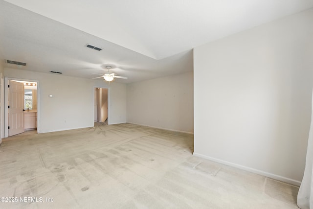 empty room featuring visible vents, light colored carpet, and baseboards