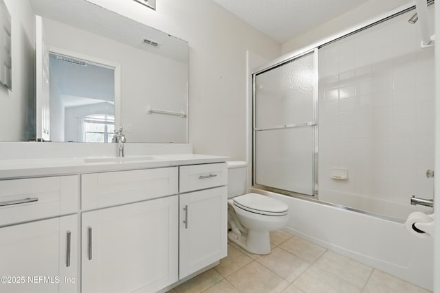 full bath with vanity, visible vents, a textured ceiling, tile patterned floors, and toilet