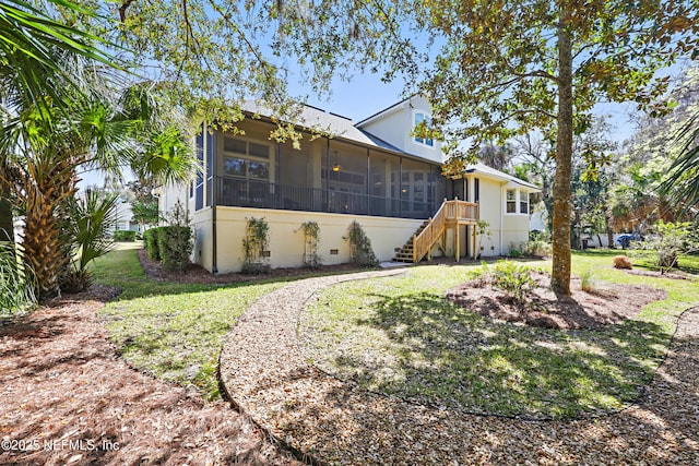 view of front of home featuring a front yard and a sunroom