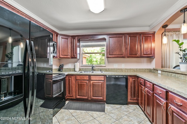 kitchen with light countertops, a sink, decorative light fixtures, and black appliances