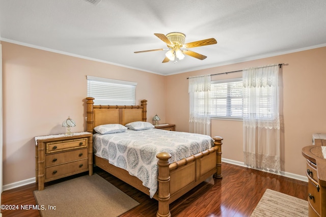 bedroom with crown molding, baseboards, and dark wood-type flooring