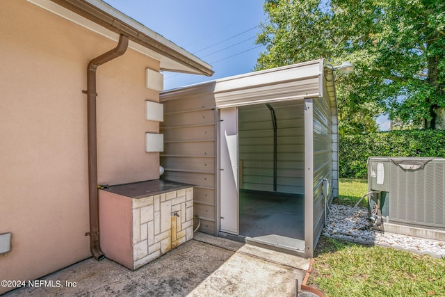 exterior space with central AC unit and stucco siding