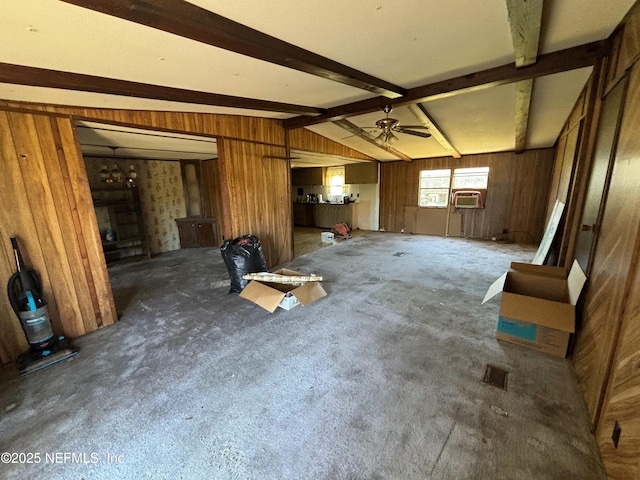 unfurnished living room featuring dark carpet, lofted ceiling with beams, a ceiling fan, wooden walls, and cooling unit