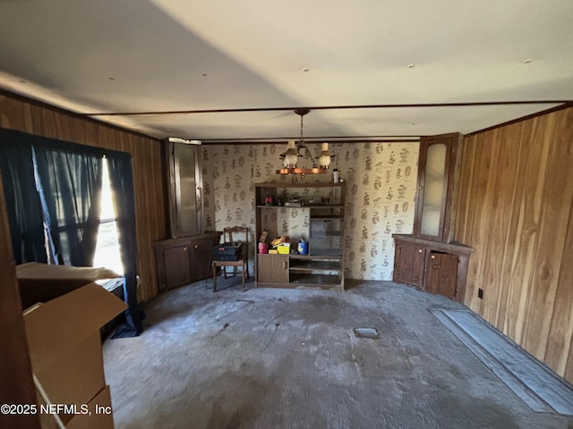 unfurnished living room featuring wooden walls