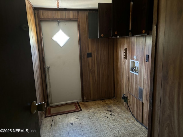 doorway featuring wood walls