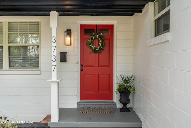 property entrance featuring concrete block siding