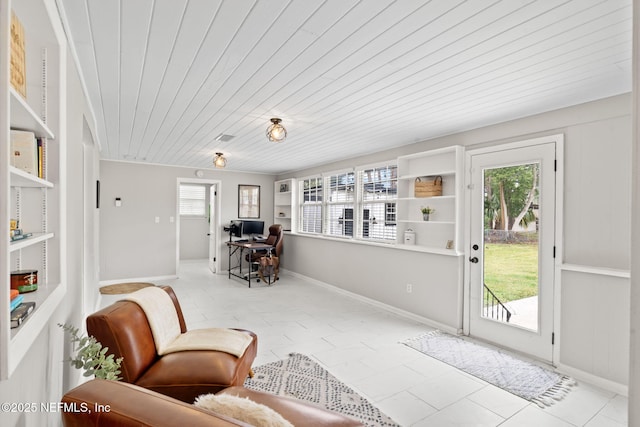 sitting room featuring wood ceiling and baseboards