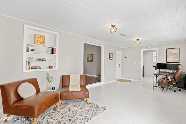 sitting room featuring built in features, marble finish floor, and visible vents