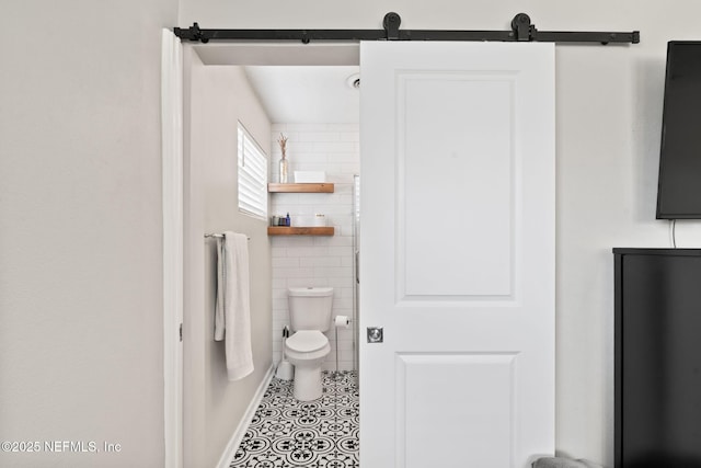 bathroom featuring tile walls, toilet, and tile patterned floors