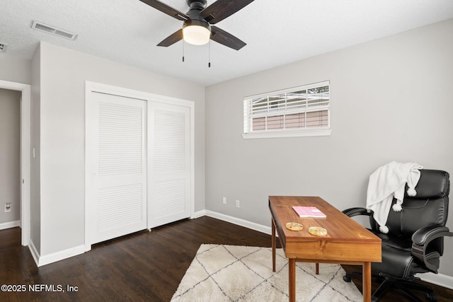 home office featuring visible vents, ceiling fan, a textured ceiling, wood finished floors, and baseboards