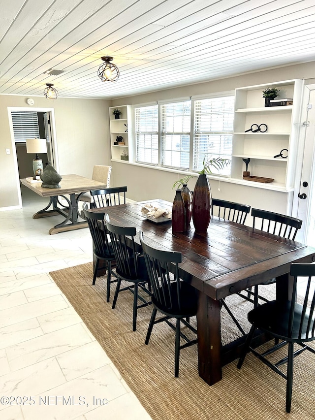 dining space with wooden ceiling