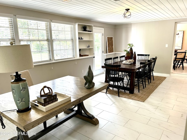 dining area featuring wood ceiling