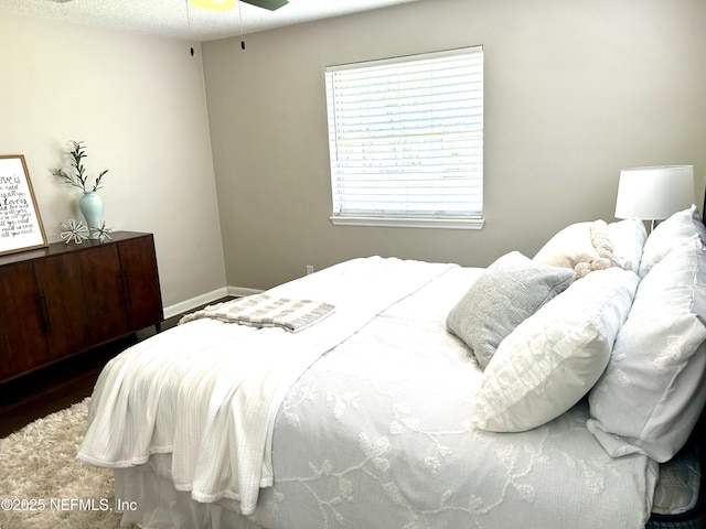 bedroom featuring baseboards and wood finished floors