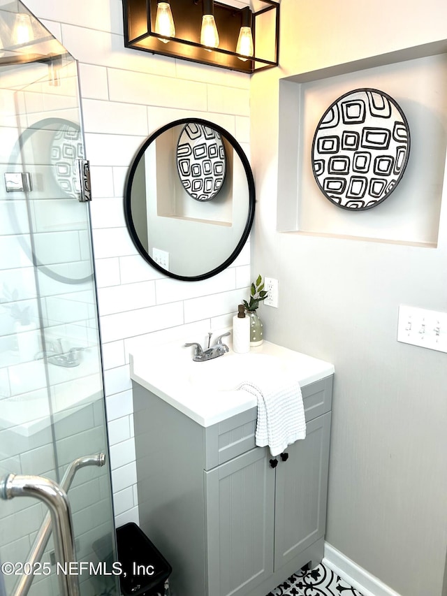 bathroom with a shower stall and vanity