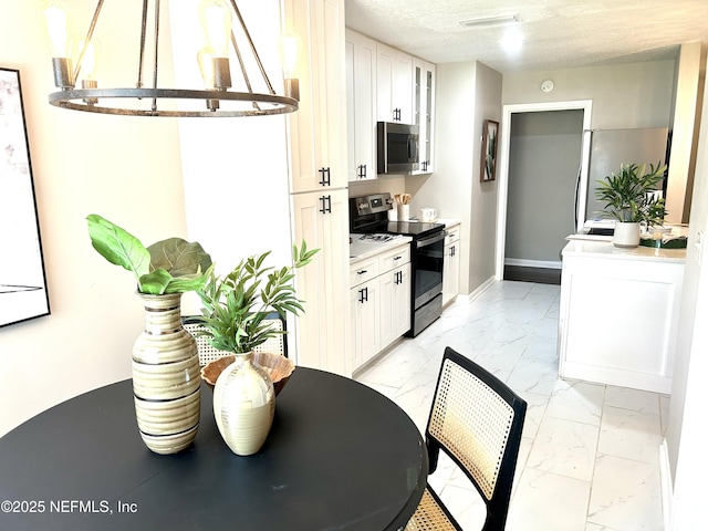 kitchen with stainless steel appliances, glass insert cabinets, marble finish floor, light countertops, and white cabinets