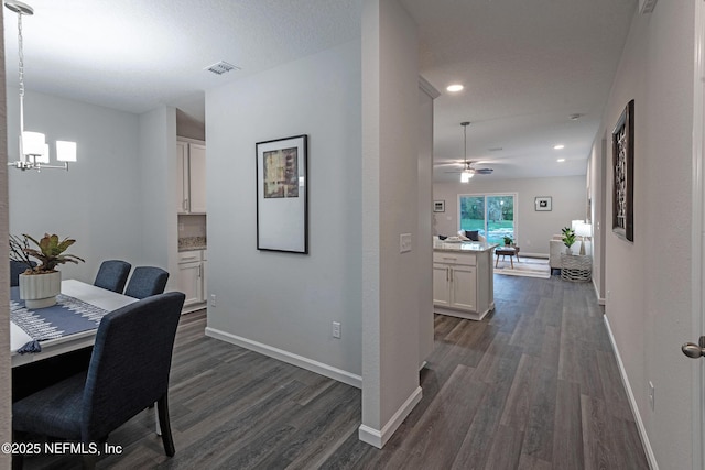 office area with visible vents, baseboards, and dark wood-style flooring