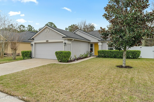 ranch-style home featuring a garage, driveway, fence, a front yard, and stucco siding