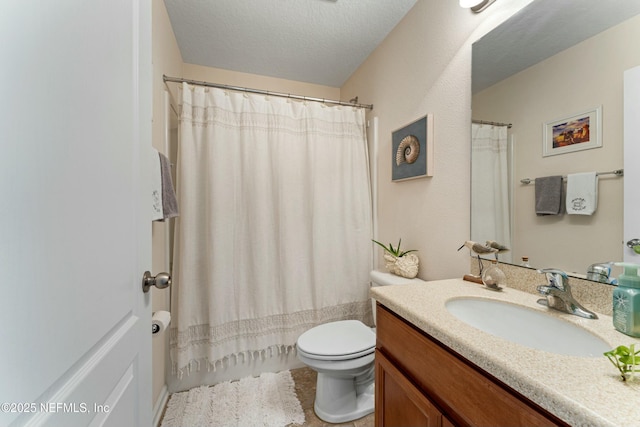 bathroom with a textured ceiling, a shower with shower curtain, vanity, and toilet