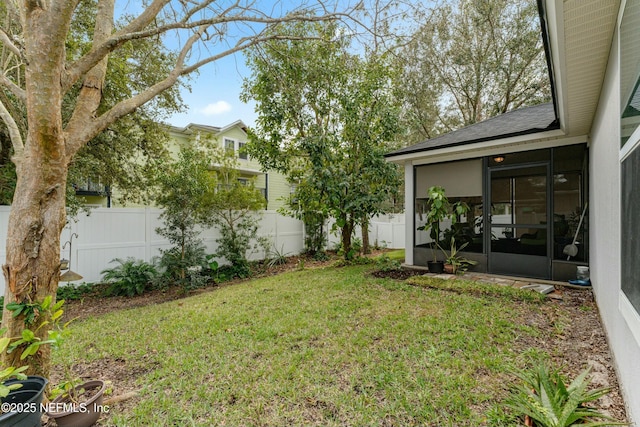 view of yard featuring fence private yard and a sunroom