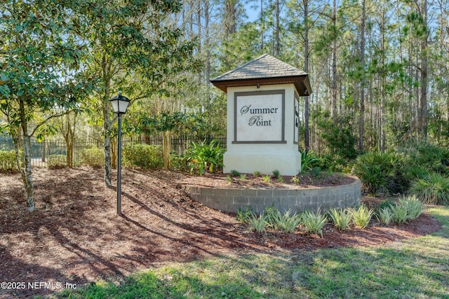 community sign featuring fence