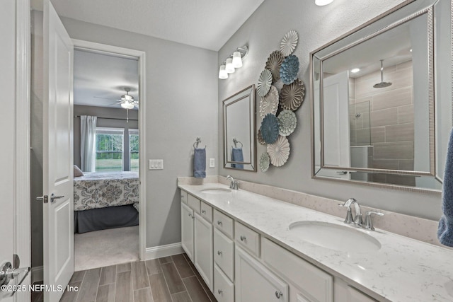 full bathroom with a sink, double vanity, wood finish floors, and connected bathroom