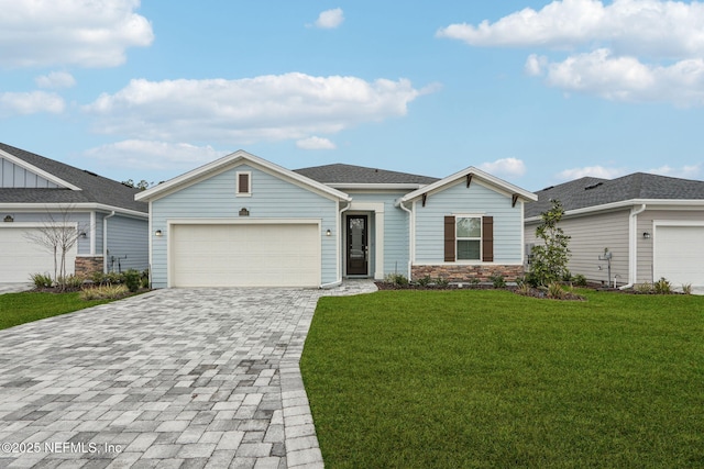 ranch-style house featuring a garage, a front lawn, and decorative driveway