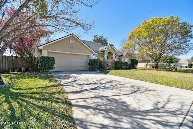 view of front of property featuring stucco siding, concrete driveway, an attached garage, fence, and a front lawn