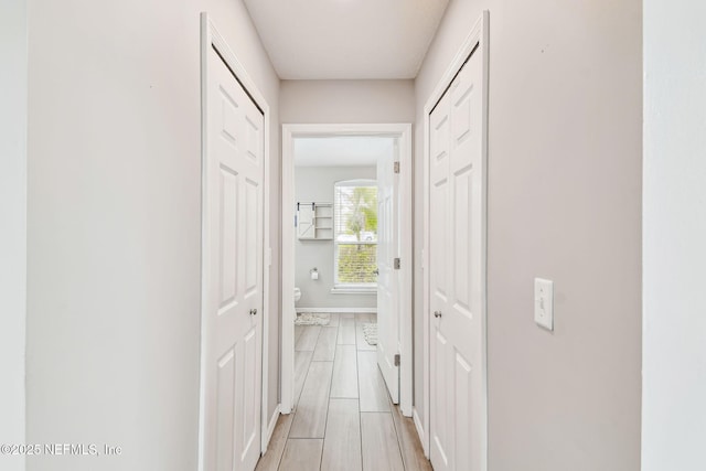 corridor featuring baseboards