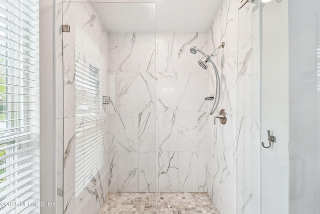 full bath featuring a marble finish shower