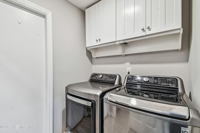 laundry room with separate washer and dryer and cabinet space