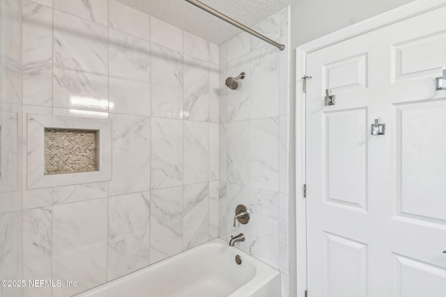 full bath with  shower combination and a textured ceiling