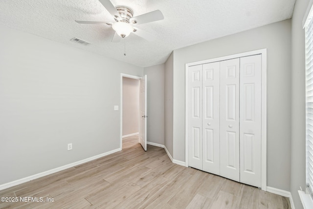 unfurnished bedroom featuring visible vents, light wood-style flooring, and baseboards