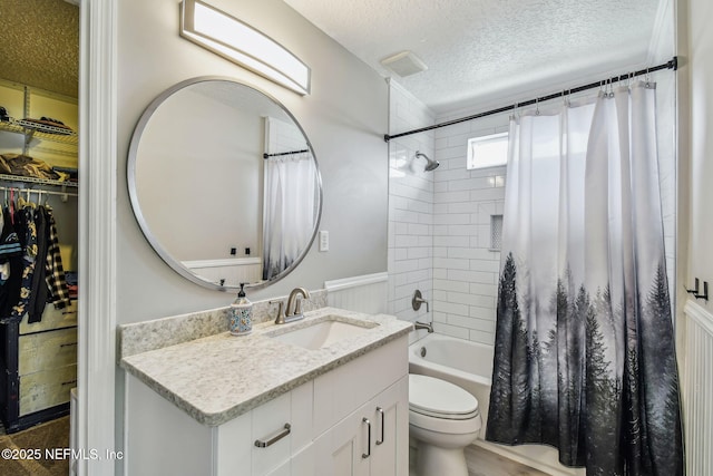 full bathroom featuring visible vents, toilet, shower / bathtub combination with curtain, a textured ceiling, and vanity