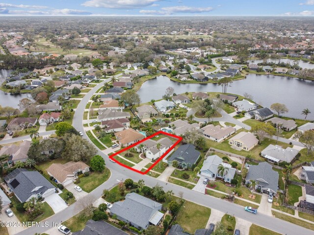 drone / aerial view featuring a water view and a residential view