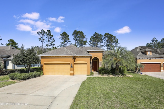 view of front of house with a garage, concrete driveway, a front lawn, and stucco siding