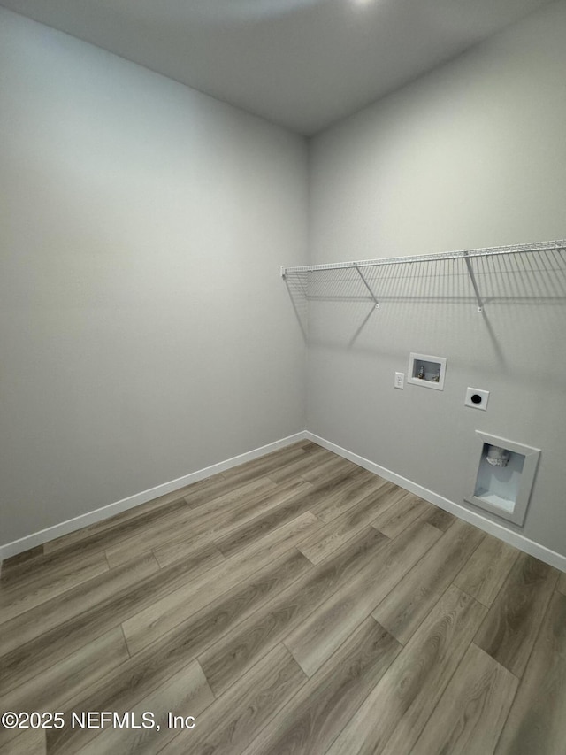 laundry room featuring hookup for a washing machine, hookup for an electric dryer, wood finished floors, laundry area, and baseboards