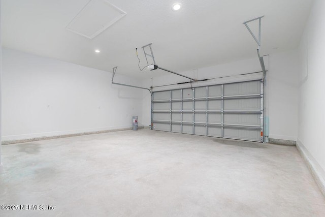 garage featuring a garage door opener and baseboards