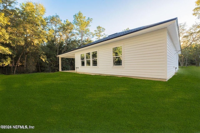 view of side of home featuring a lawn