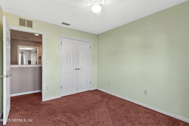 unfurnished bedroom with carpet, visible vents, and baseboards